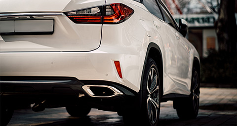 the back view of a clean white car with no dents or damage